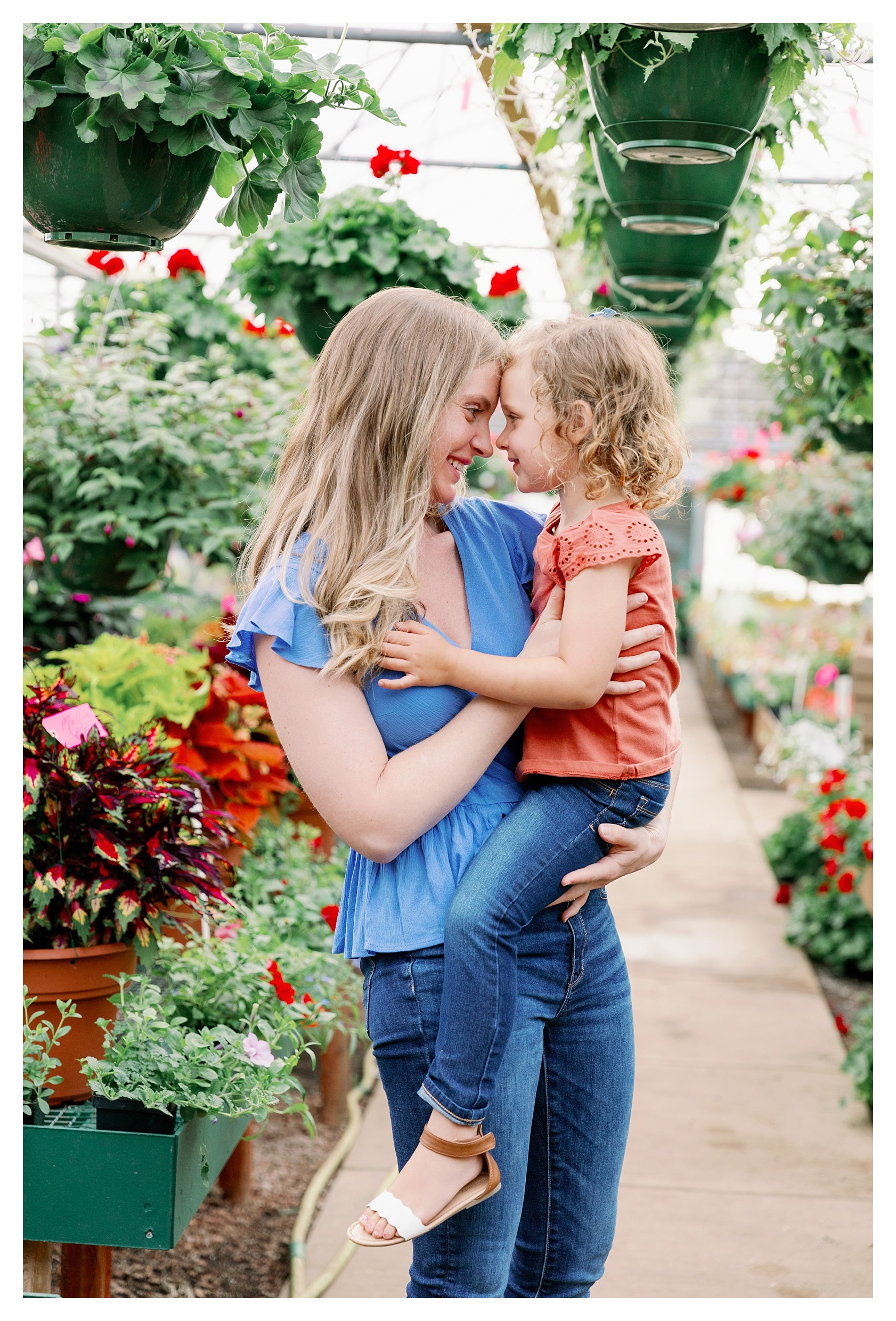 mom and toddler girl pose in greenhouse at Rib Mountain Greenhouse