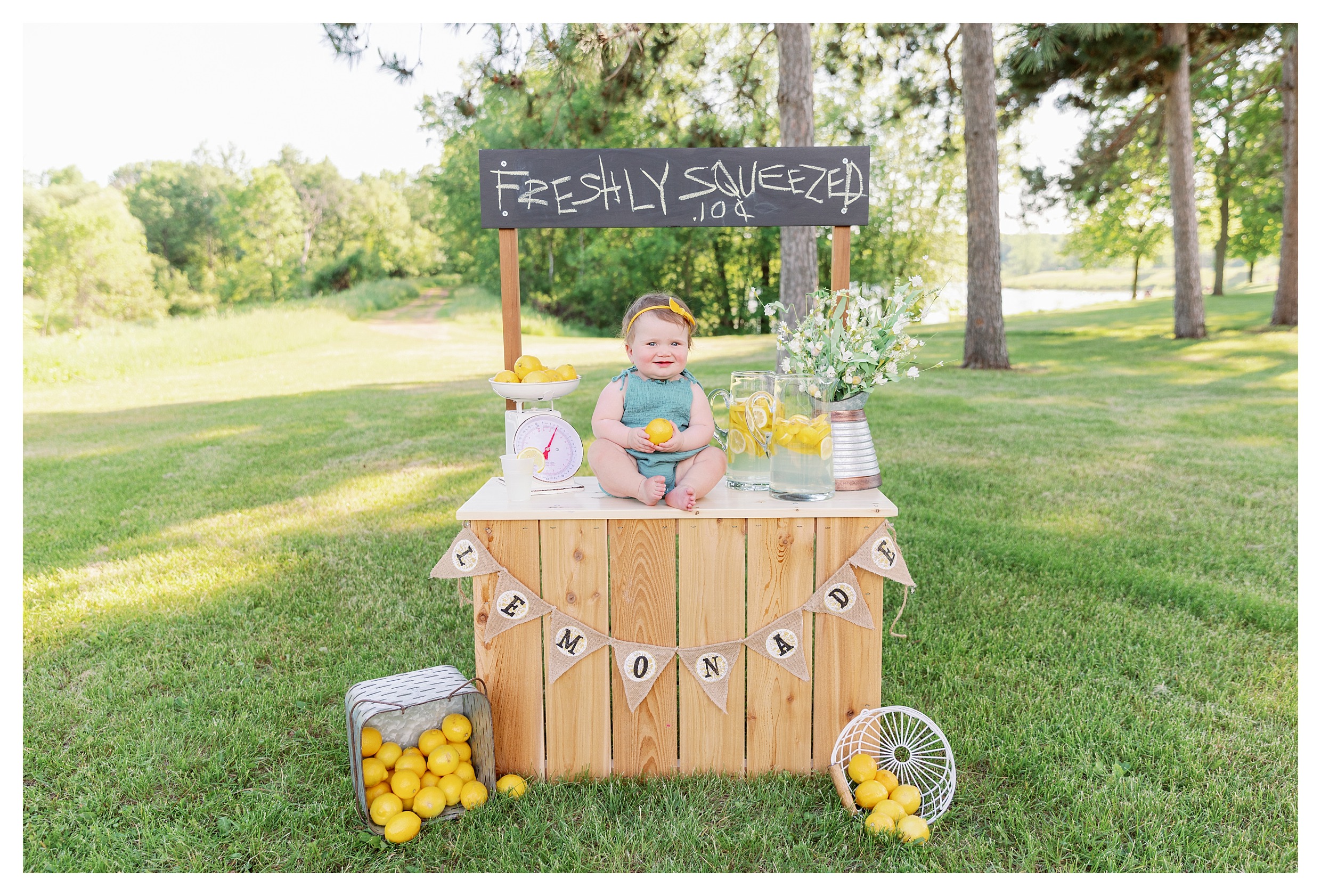 9 month little girl poses during her lemonade stand mini session in Wausau, WI at Sunnyvale Park 